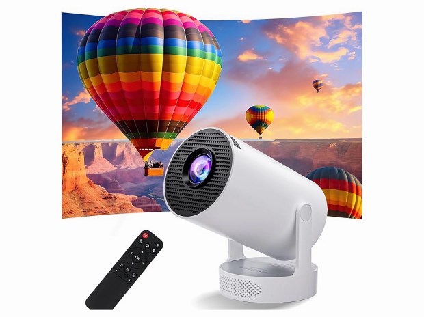Portable projector projecting hot air balloons over a canyon.
