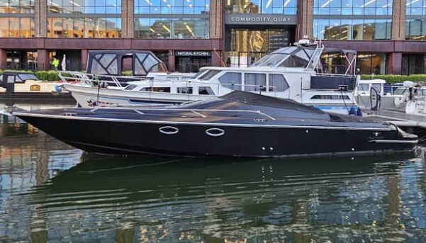 Black speedboat docked at Commodity Quay.