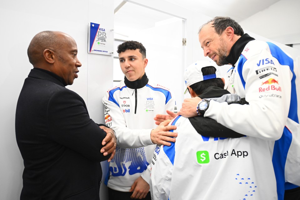 Anthony Hamilton, Isack Hadjar, and others in the garage at the F1 Grand Prix of Australia.