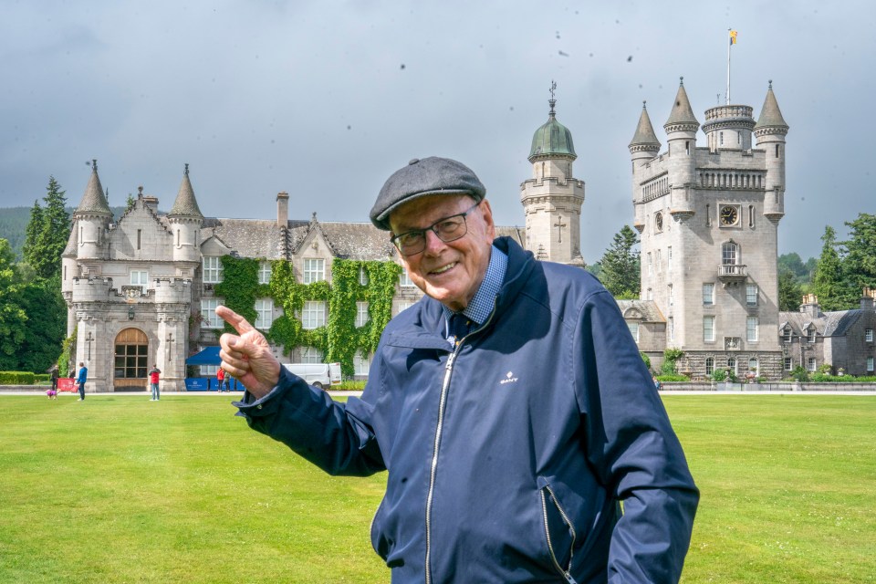 A man points toward Balmoral Castle.