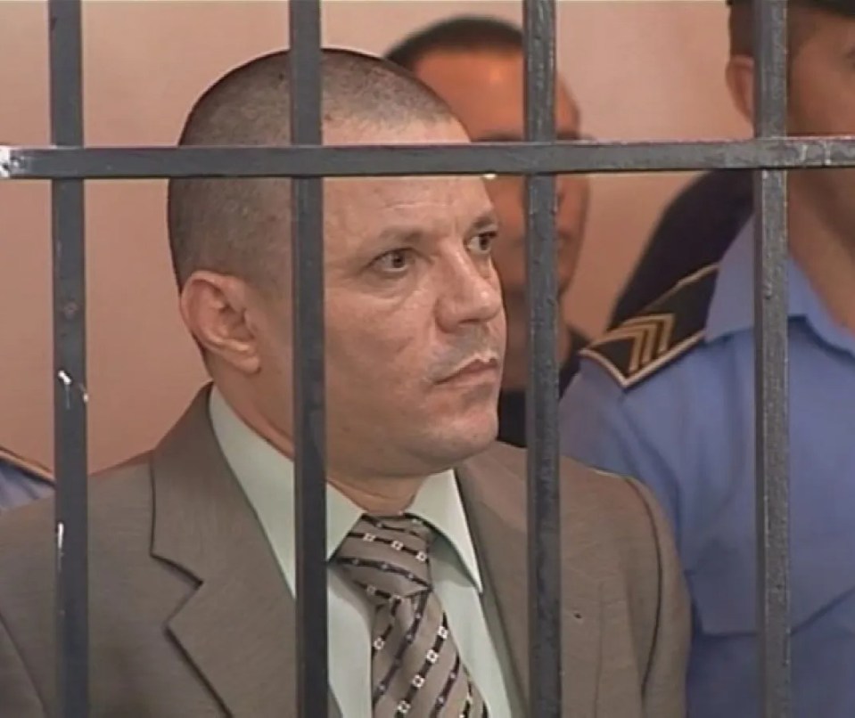 Albanian mob boss Maksim Cela in a courtroom cage.