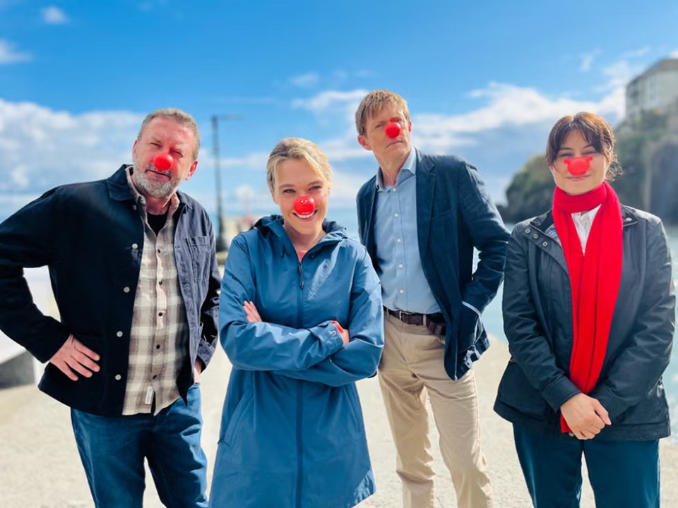 Four people wearing red noses.