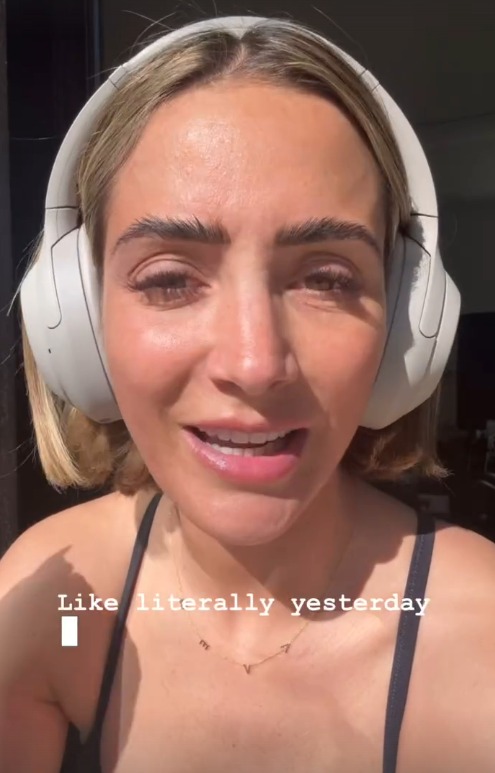 Close-up of a woman wearing headphones, speaking.