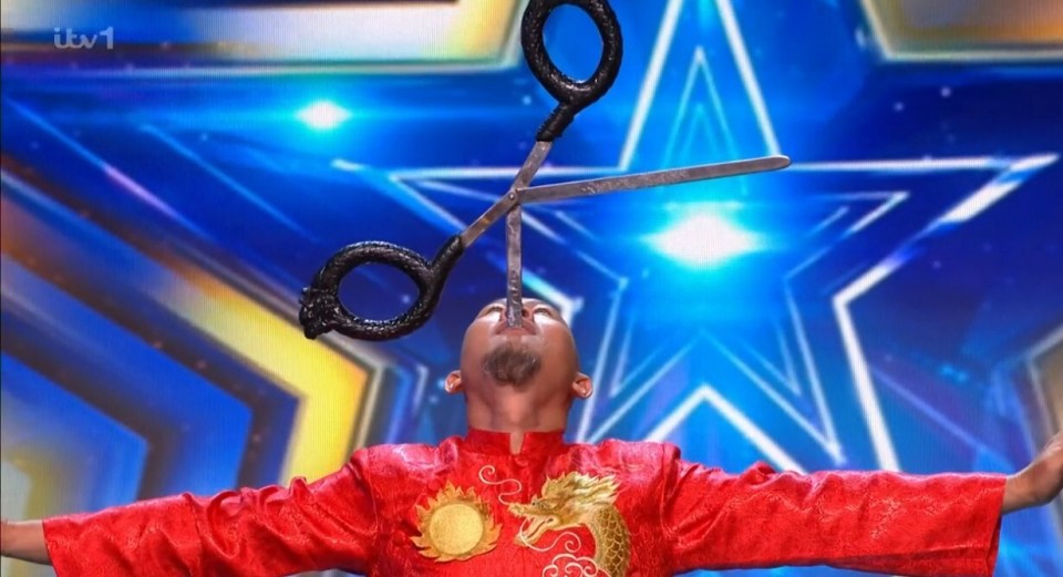A man balancing open scissors on his chin during a Britain's Got Talent audition.
