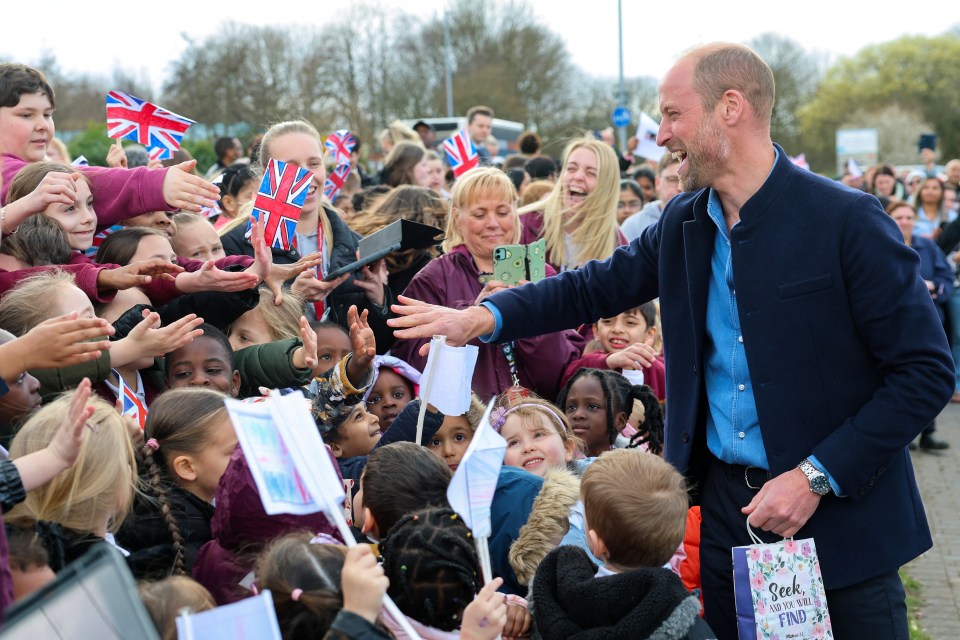 Prince William greeting schoolchildren.