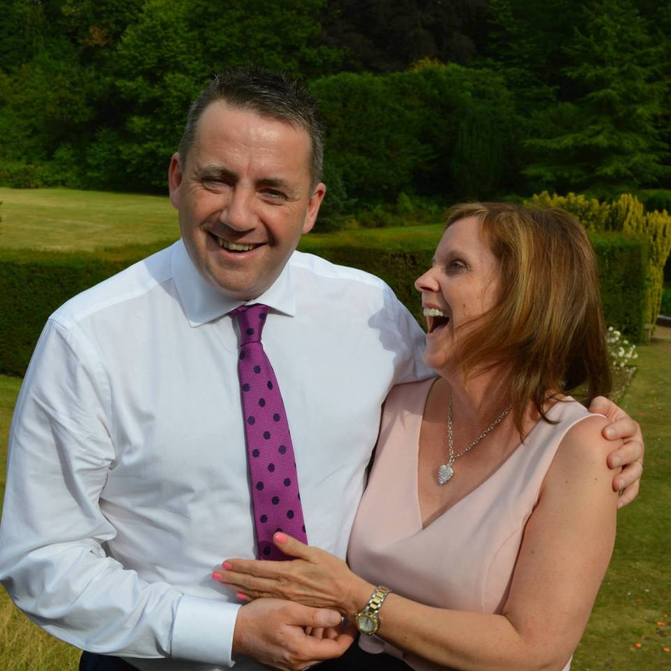 Laughing couple outdoors.