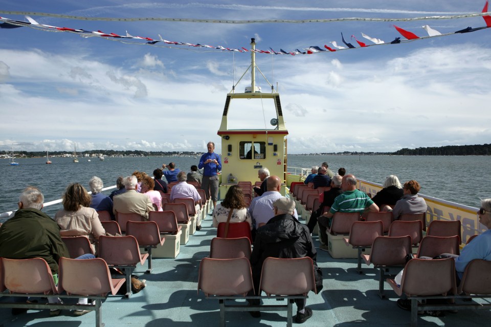 Passengers on a ferry leaving Poole Harbour.