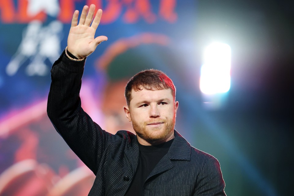 Canelo Alvarez waves to the crowd at a press conference.