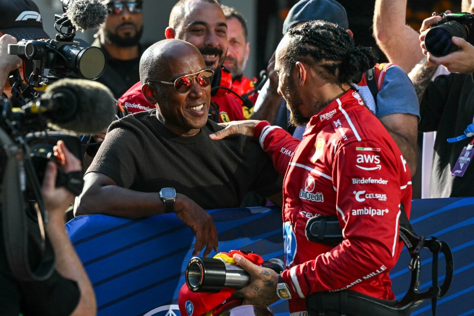 Lewis Hamilton celebrating with his father after winning pole position.