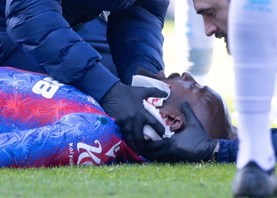 Injured soccer player receiving medical attention on the field.
