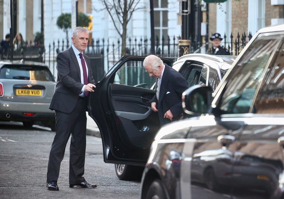 King Charles getting into a car.