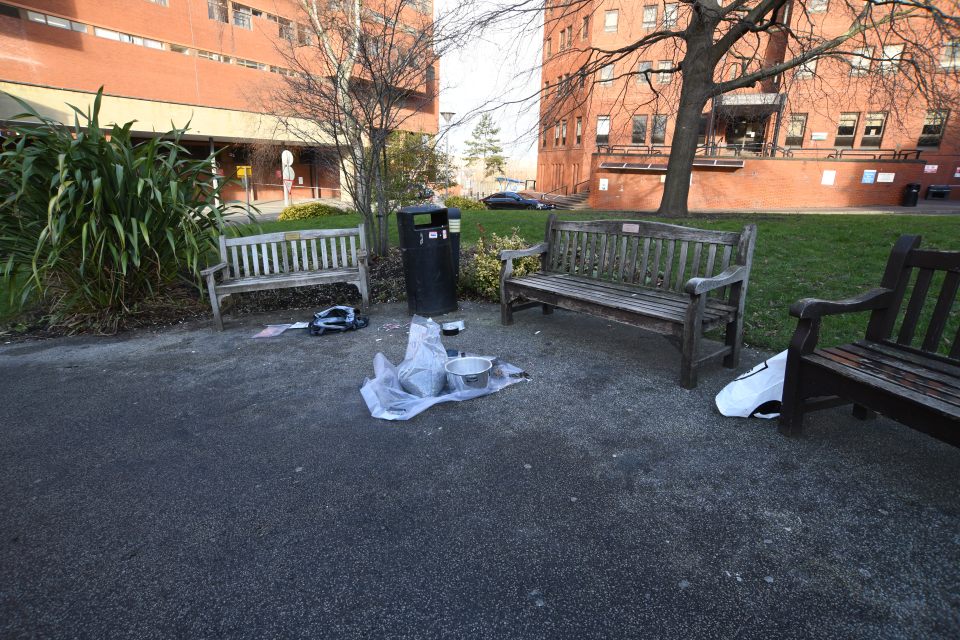 Pressure cooker bomb components near park benches outside a hospital.