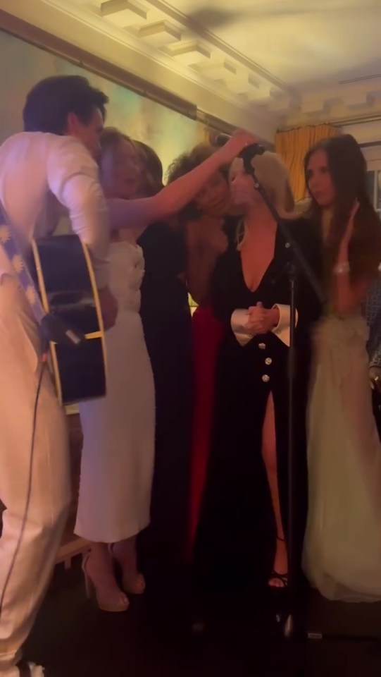 Cruz Beckham playing guitar as the Spice Girls sing at Victoria Beckham's birthday party.
