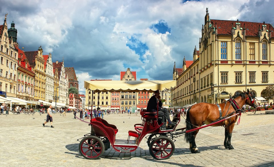 Horse-drawn carriage in Wroclaw market square.
