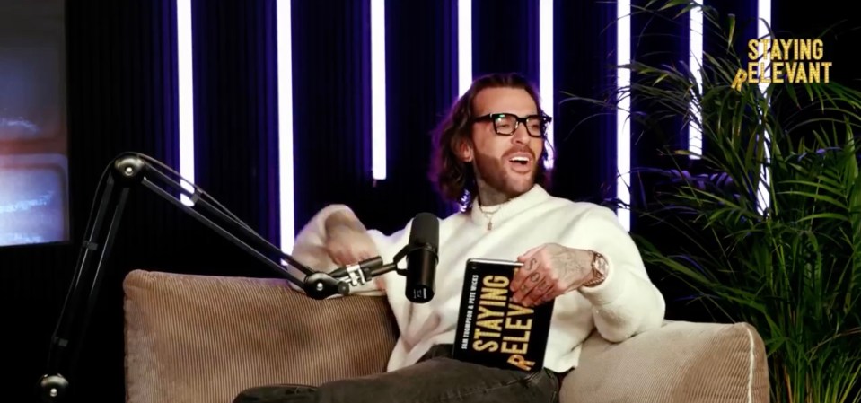 Pete Wicks holding his book, "Staying Relevant," on a podcast.