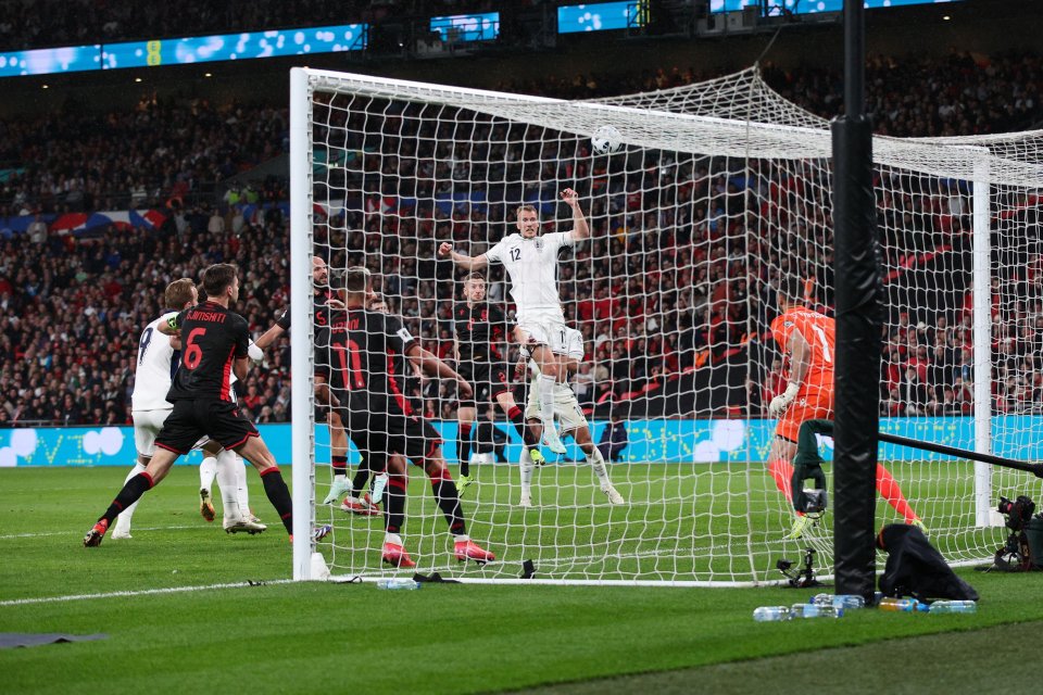 Dan Burn of England heads the ball toward the goal during a soccer match.