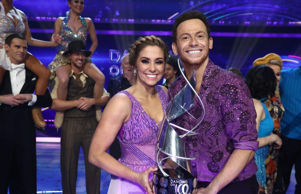 Joe Swash and Alex Murphy, winners of Dancing on Ice 2020, holding the trophy.