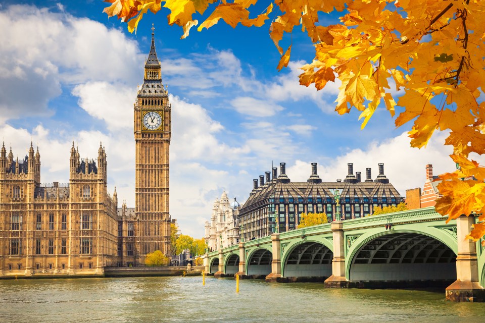 Big Ben and the Houses of Parliament in London, viewed from across a bridge.