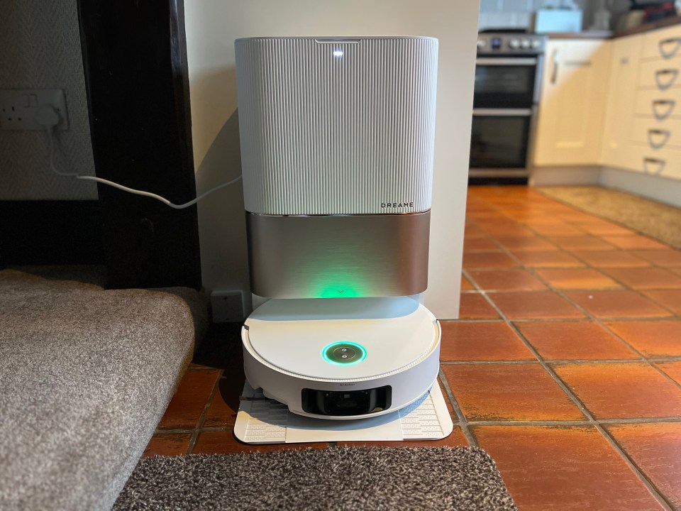 Dreame robot vacuum charging on its dock.