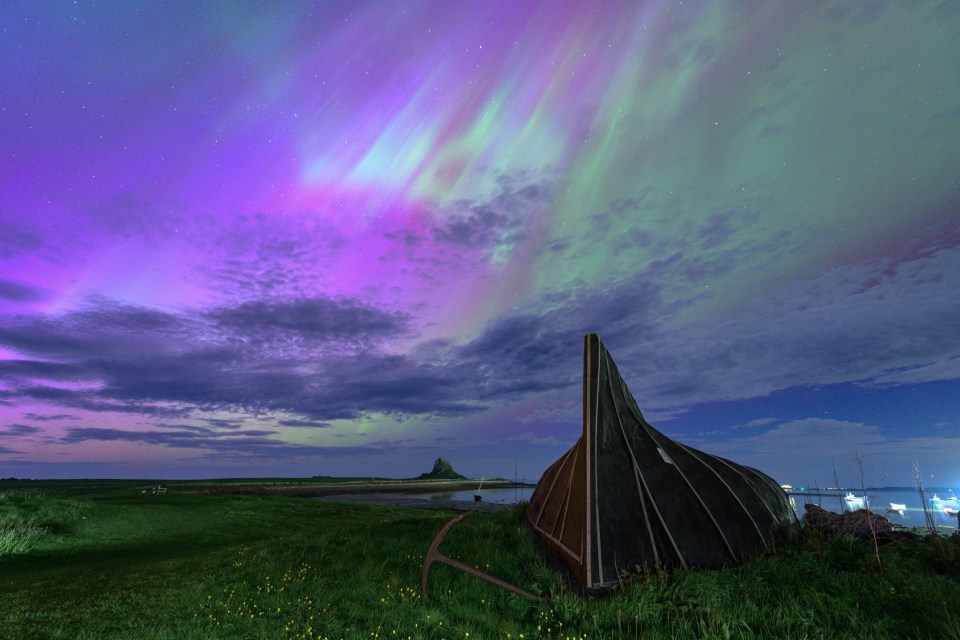 Upturned boats are used as storage sheds with the astonishing Aurora Borealis over the famous Holy Island of Lindisfarne. The Castel can be seen in the distance.<br />
This was the biggest solar storm in more than 20 years happened on the 10th and 11th of May 2024.
