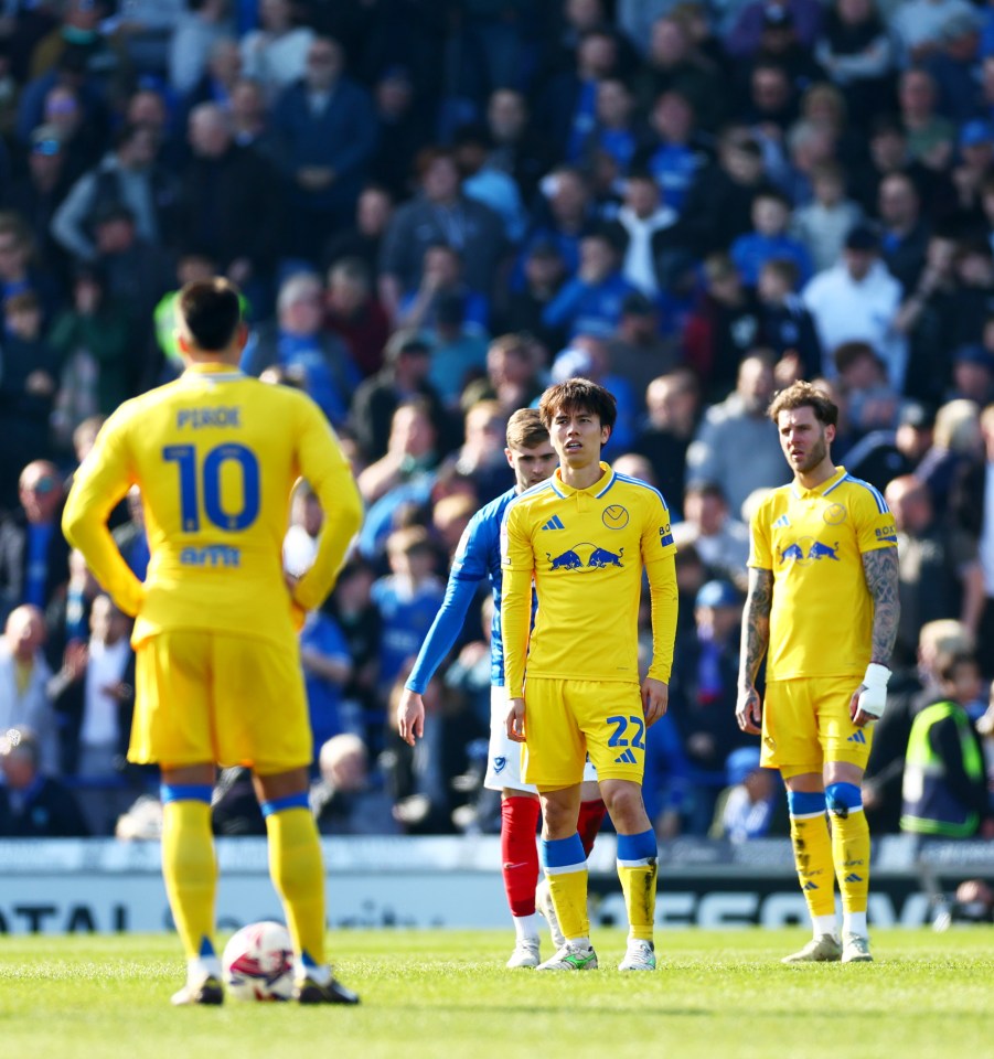 Leeds players looking dejected after conceding a goal.
