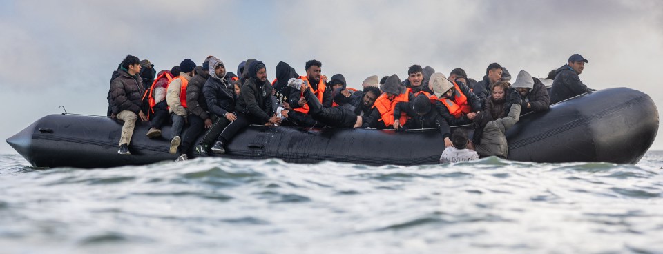 Migrants in a small boat attempting to cross the English Channel.