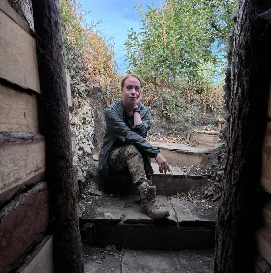 Woman sitting in a wooden trench.
