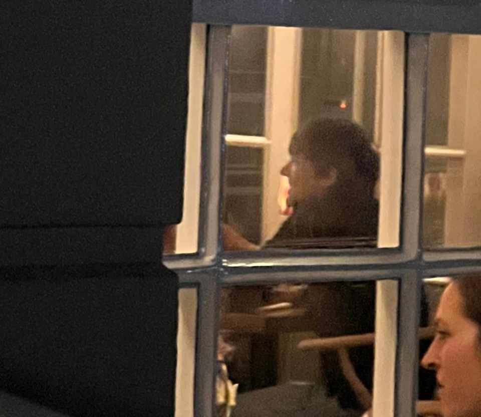 Zara McDermott and Louis Tomlinson seen through a window.