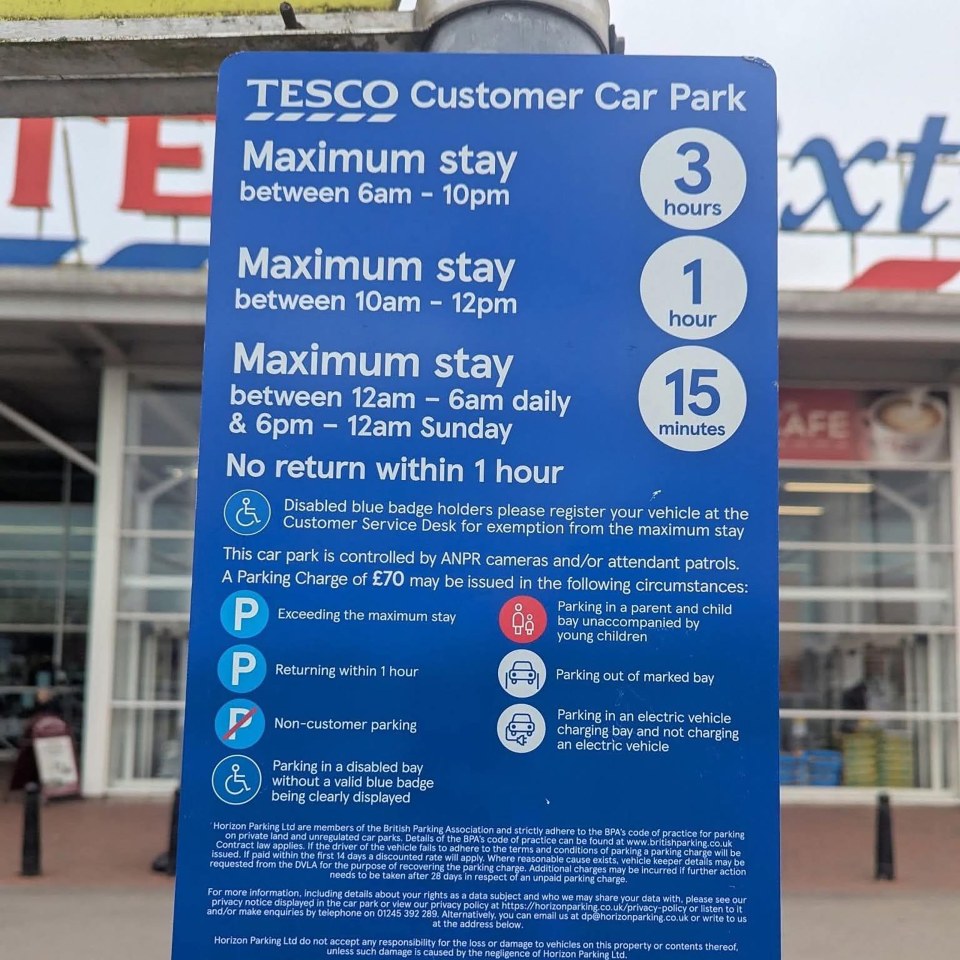 Tesco customer car park information sign: maximum stay times and parking charges.