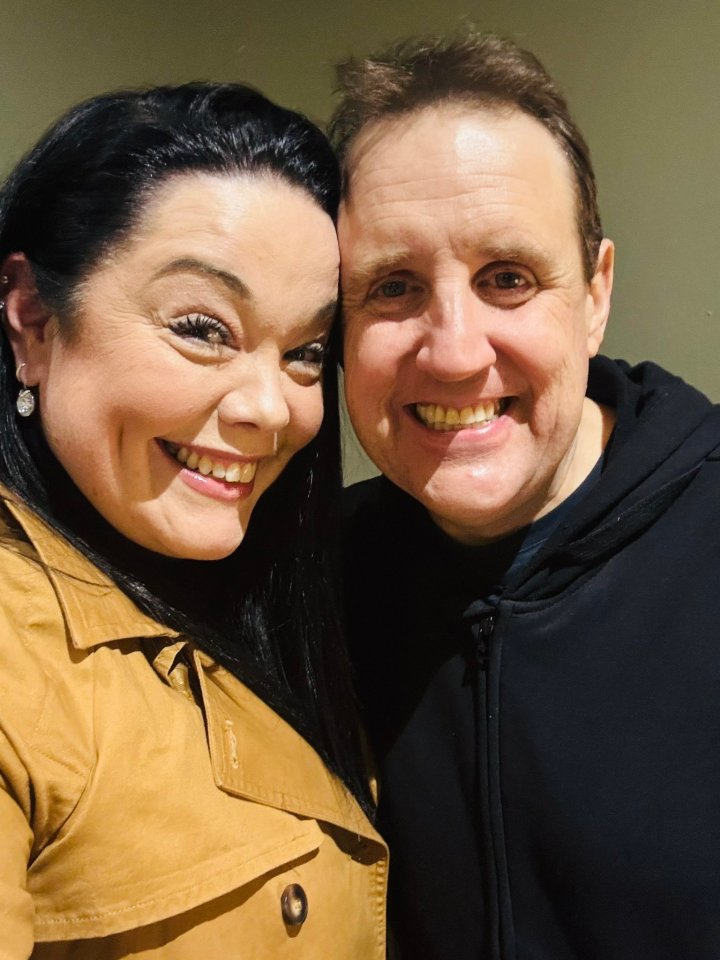 Peter Kay and Lisa Riley smiling for a selfie.