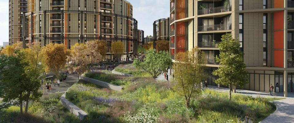 Illustration of renovated London gasworks converted into apartments, surrounded by landscaped gardens.