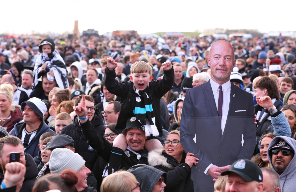 Newcastle United fans celebrating with a cutout of Alan Shearer.