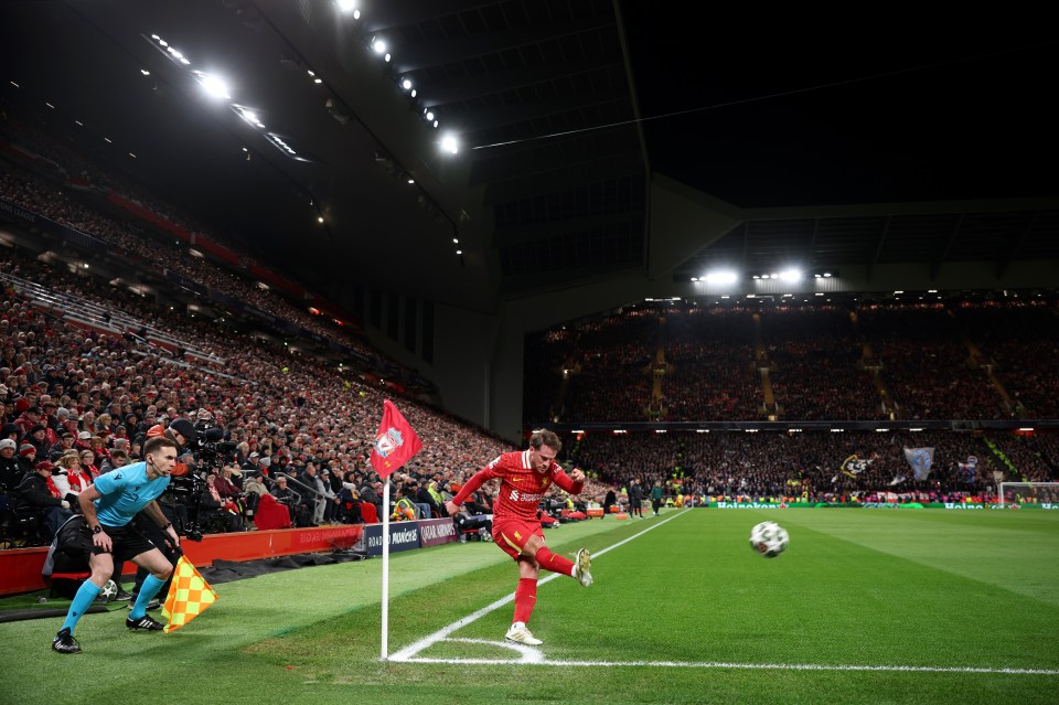 Alexis Mac Allister of Liverpool taking a corner kick during a Champions League match at Anfield.
