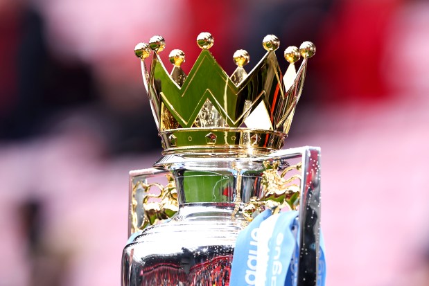 Premier League trophy with crown on top.