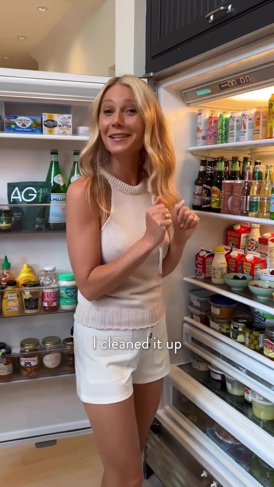 Gwyneth Paltrow standing in front of her refrigerator.
