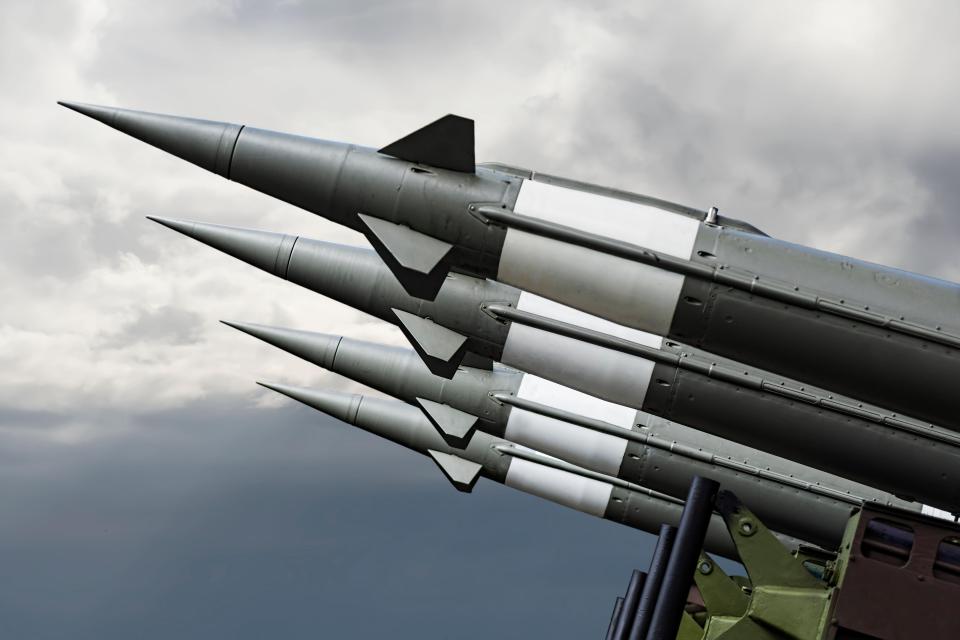 Nuclear missiles aimed at a cloudy sky.