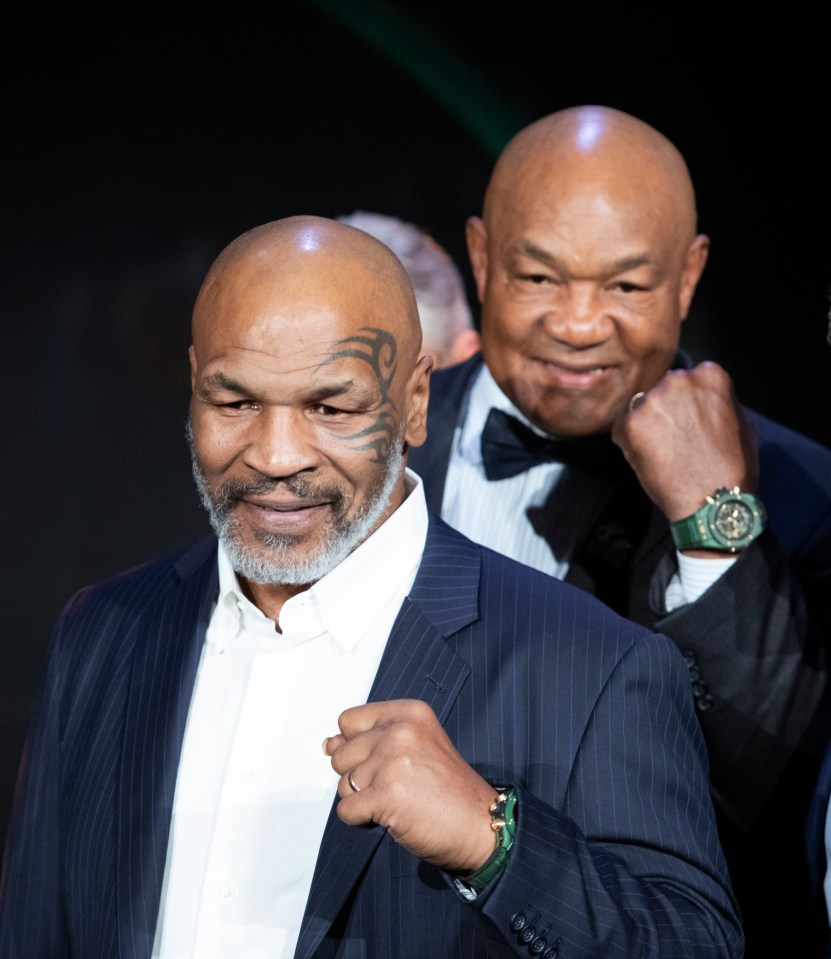 Mike Tyson and George Foreman at a gala.