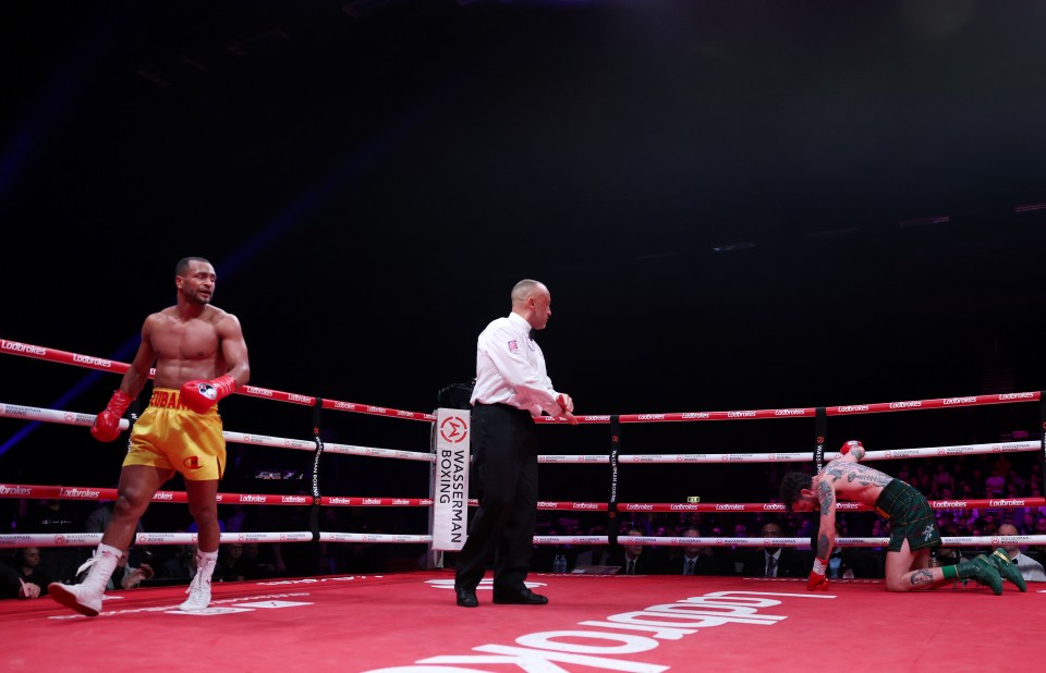 Harlem Eubank knocks down Tyrone McKenna in a boxing match.