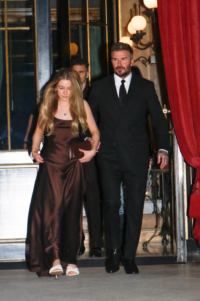 Harper Beckham and David Beckham leaving a hotel.
