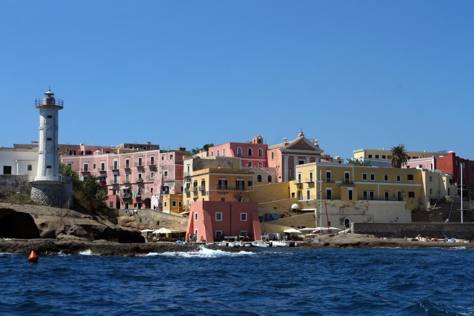 Lighthouse and colorful buildings on Ventotene Island.