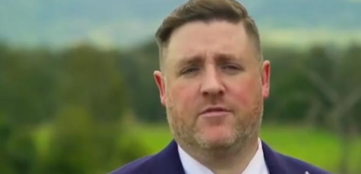 A man in a suit expressing displeasure.