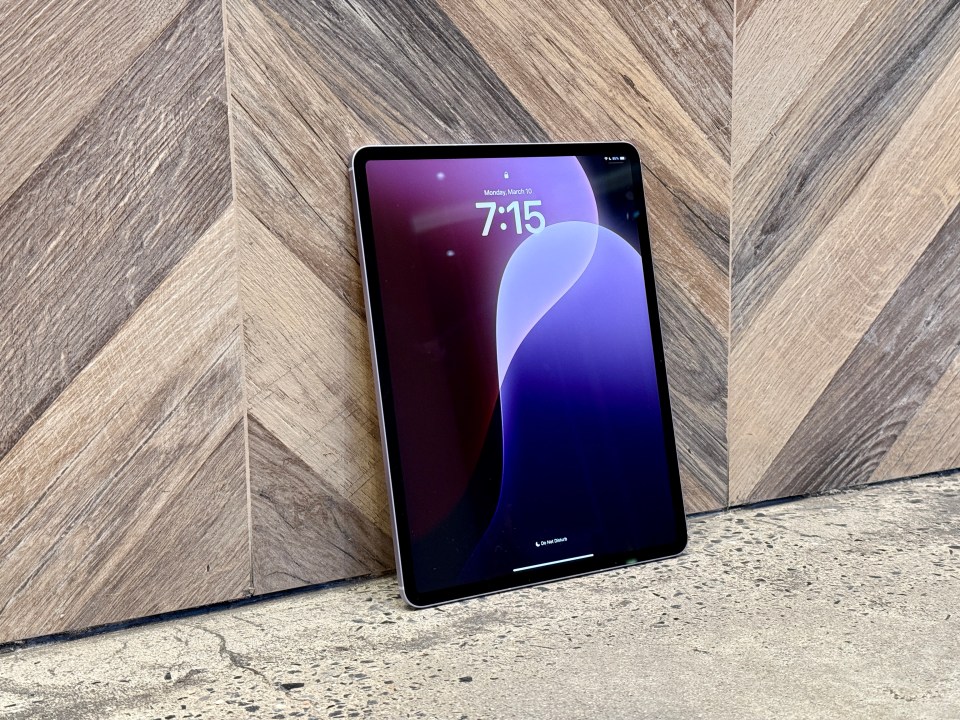 iPad Air 2025 leaning against a wood wall.