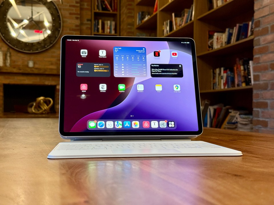 iPad Air with keyboard and screen showing apps and weather.