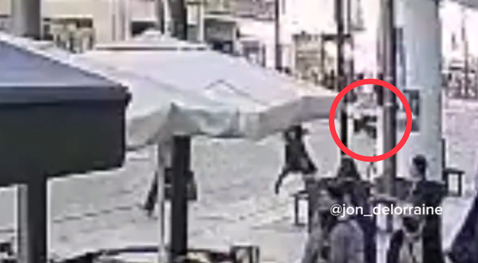 Security camera footage of a person running.