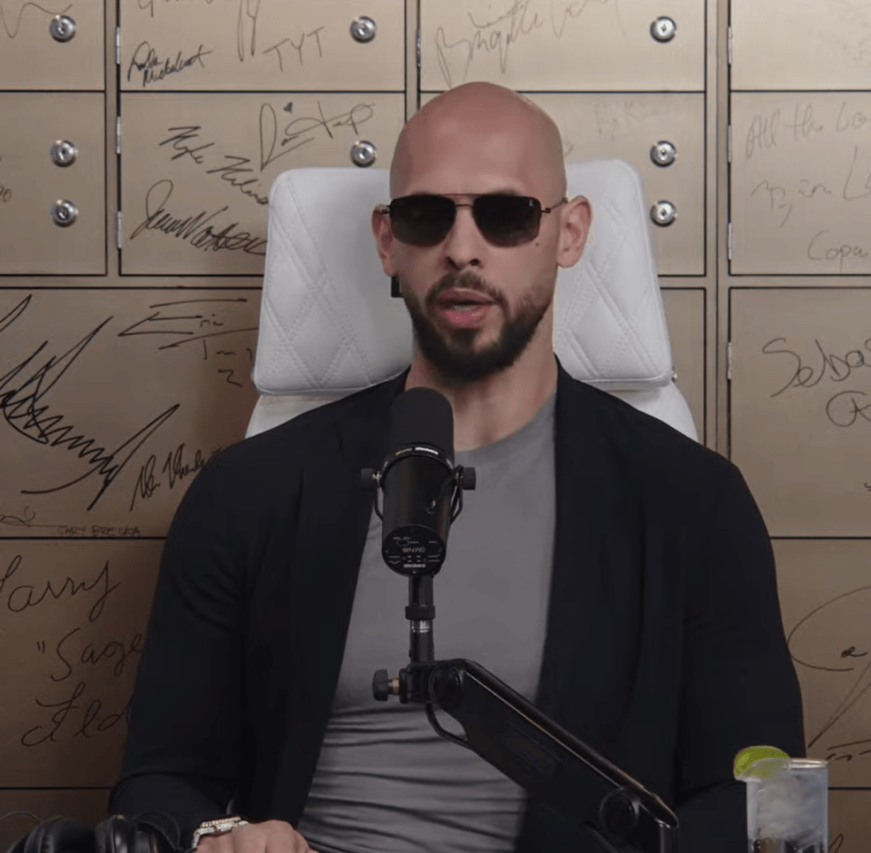 Man in sunglasses speaking into a microphone.