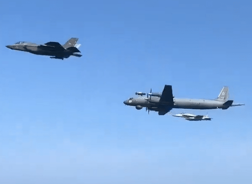 Three military aircraft in flight.