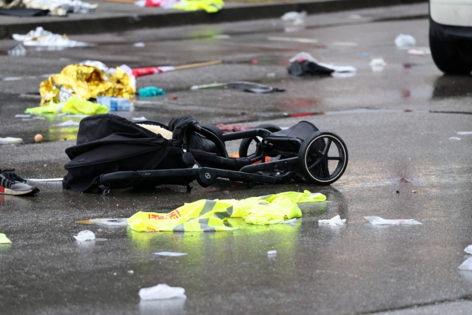 Overturned stroller and debris on the ground.