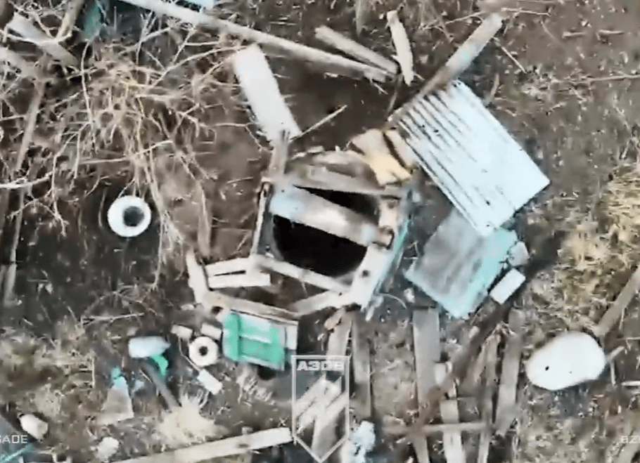 Aerial view of debris surrounding a damaged structure.