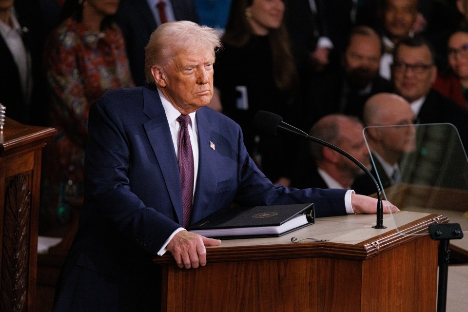Donald Trump speaking at a podium.