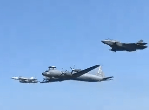 Three military aircraft in flight.